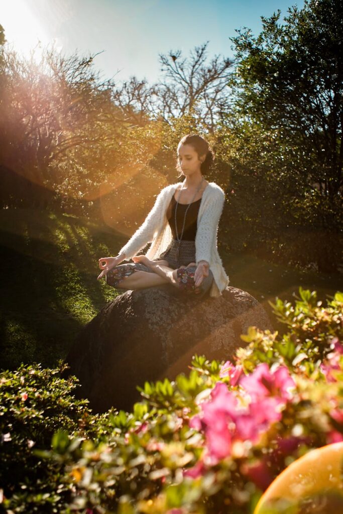 woman meditating on rock, glow up