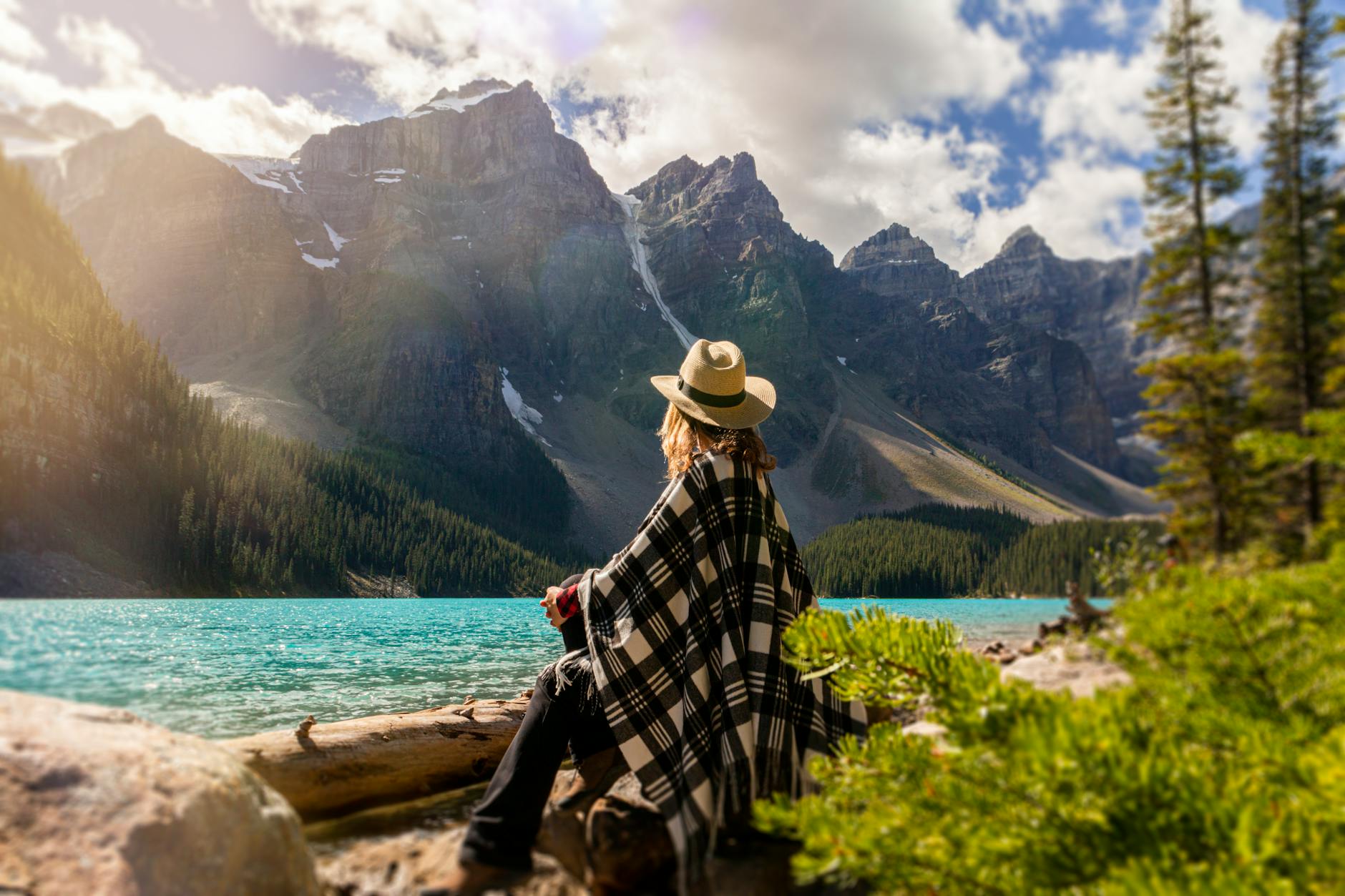 a woman sits on a rock beside the lake
meditation. Midlife
