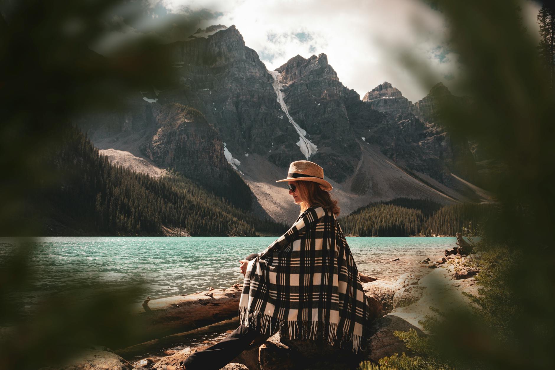 woman sitting on tree log