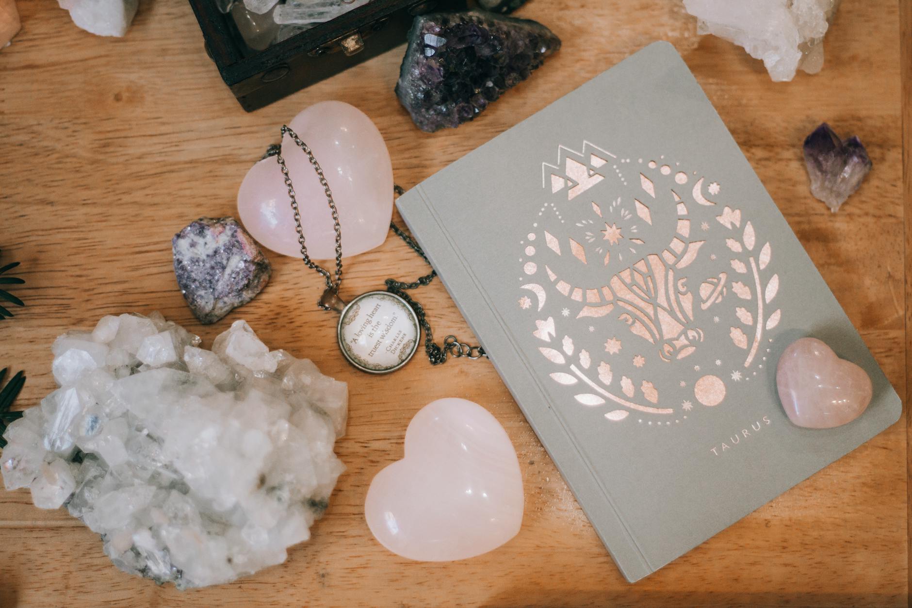 pink crystals near a notebook. grace