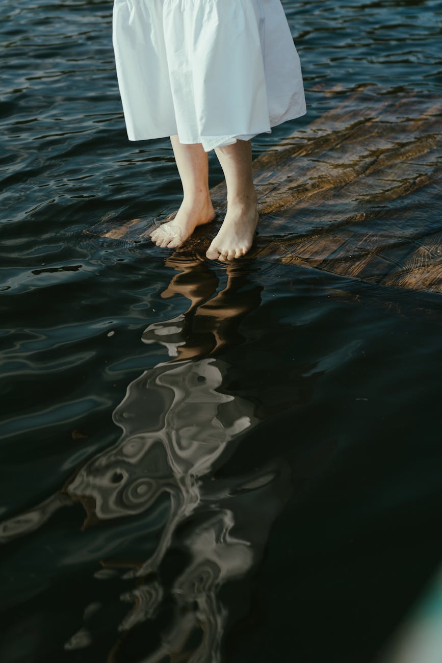 a person in white dress standing on water. spiritual