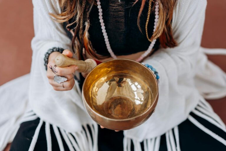 woman in white long sleeve shirt holding gold round bowl