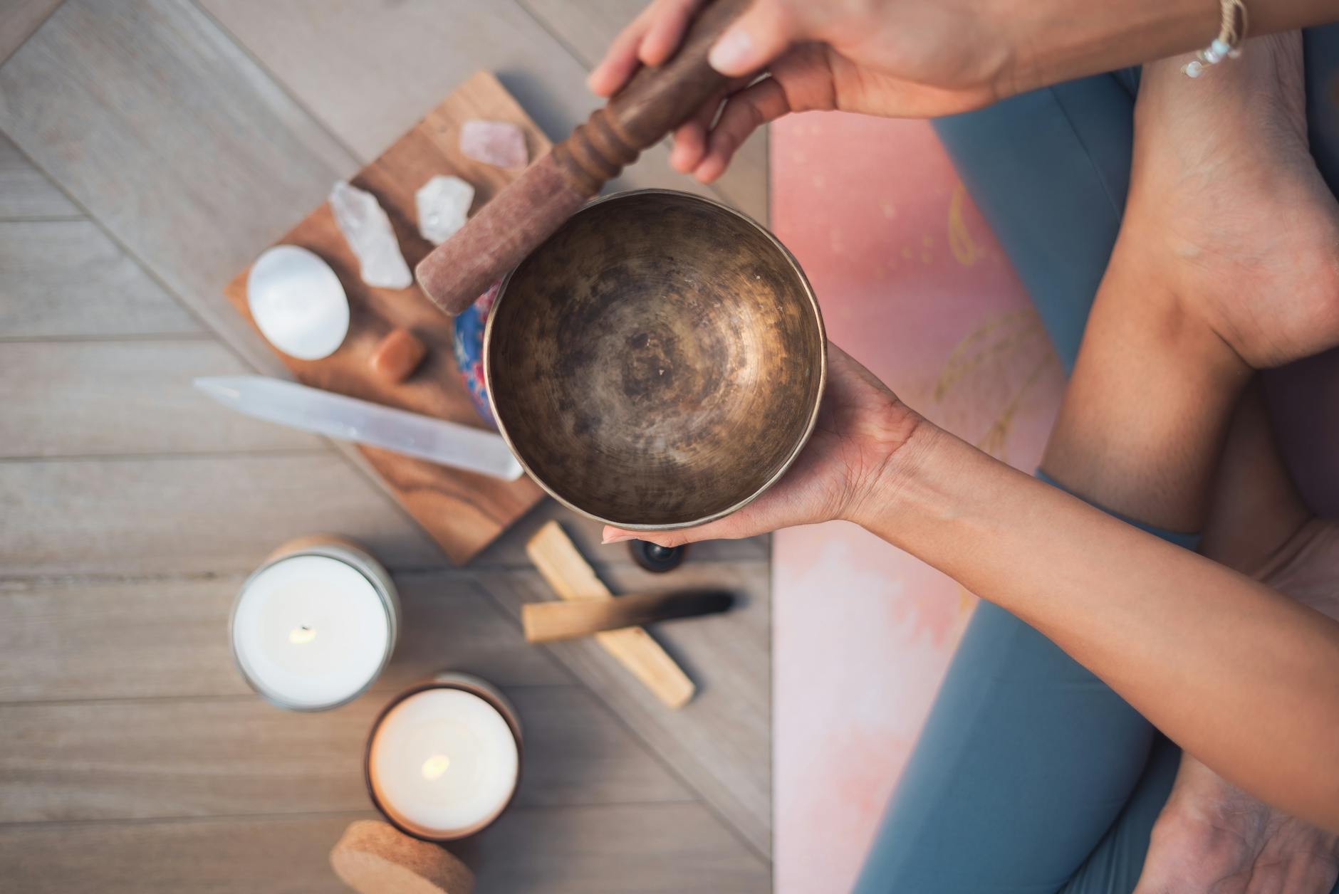 overhead shot of a person holding a tibetan singing bowl. reinvention