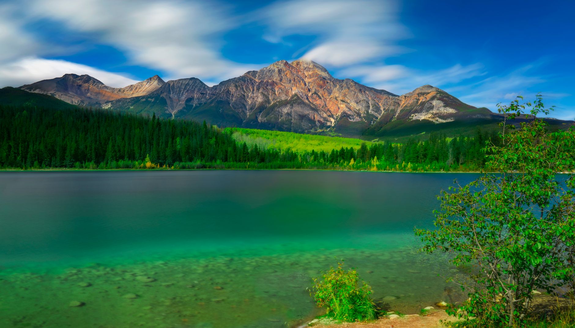forest and mountains seen from the patricia lake in jasper national park alberta canada