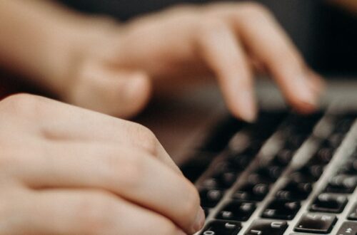 person typing on keyboard