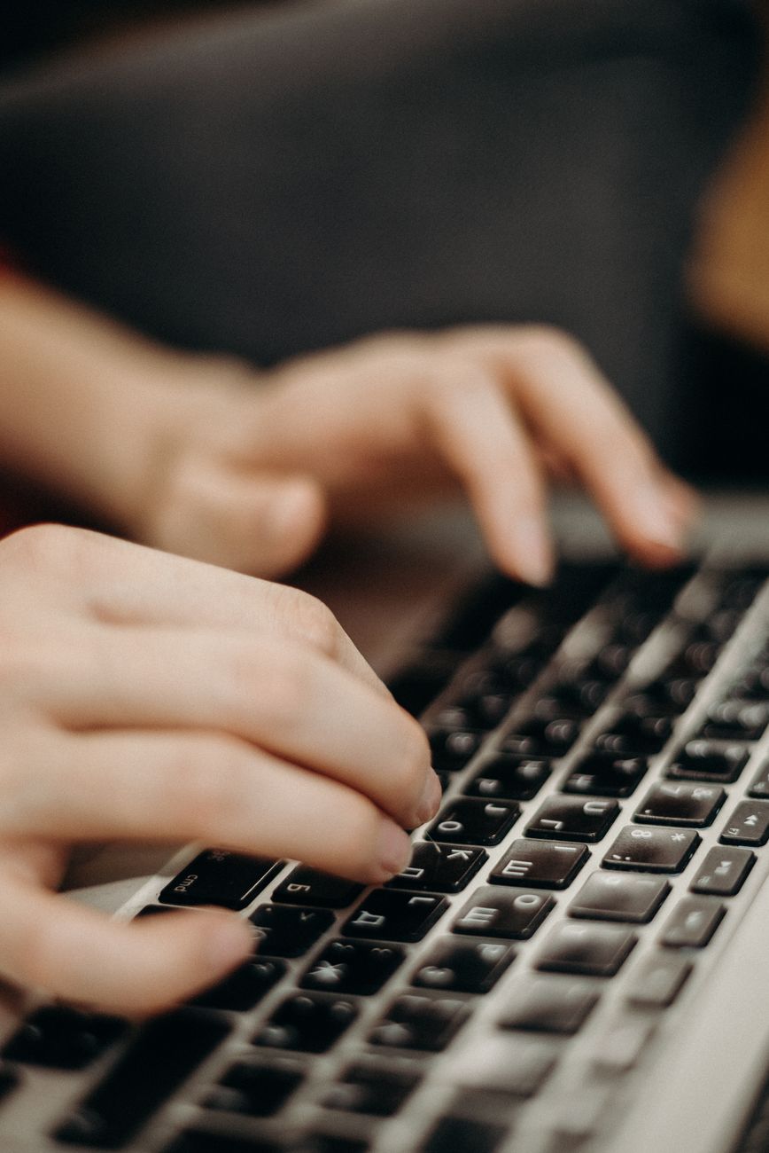 person typing on keyboard