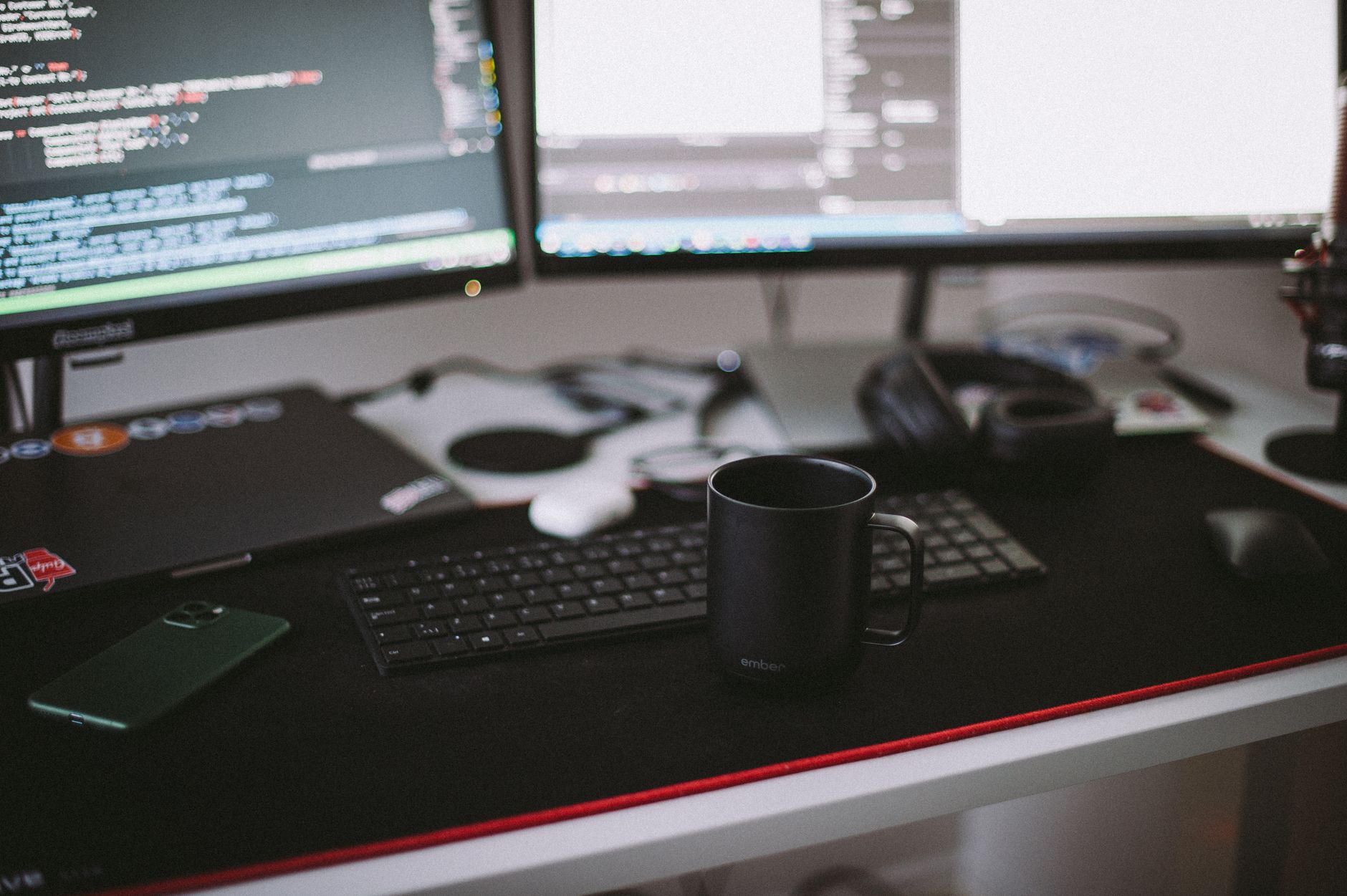black ceramic mug in front of a computer